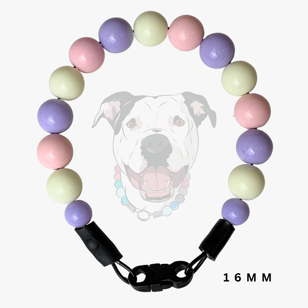 A beaded dog collar with pastel purple, pink, and pale yellow-green round beads, featuring a black plastic clasp and shown against a white background with a faint dog graphic and '16 MM' text.