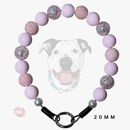 A beaded dog collar necklace made of light purple/lavender beads and glittery iridescent beads, with a black clasp and silver-toned ring, shown on a white background with a faint dog graphic and '20MM' text.