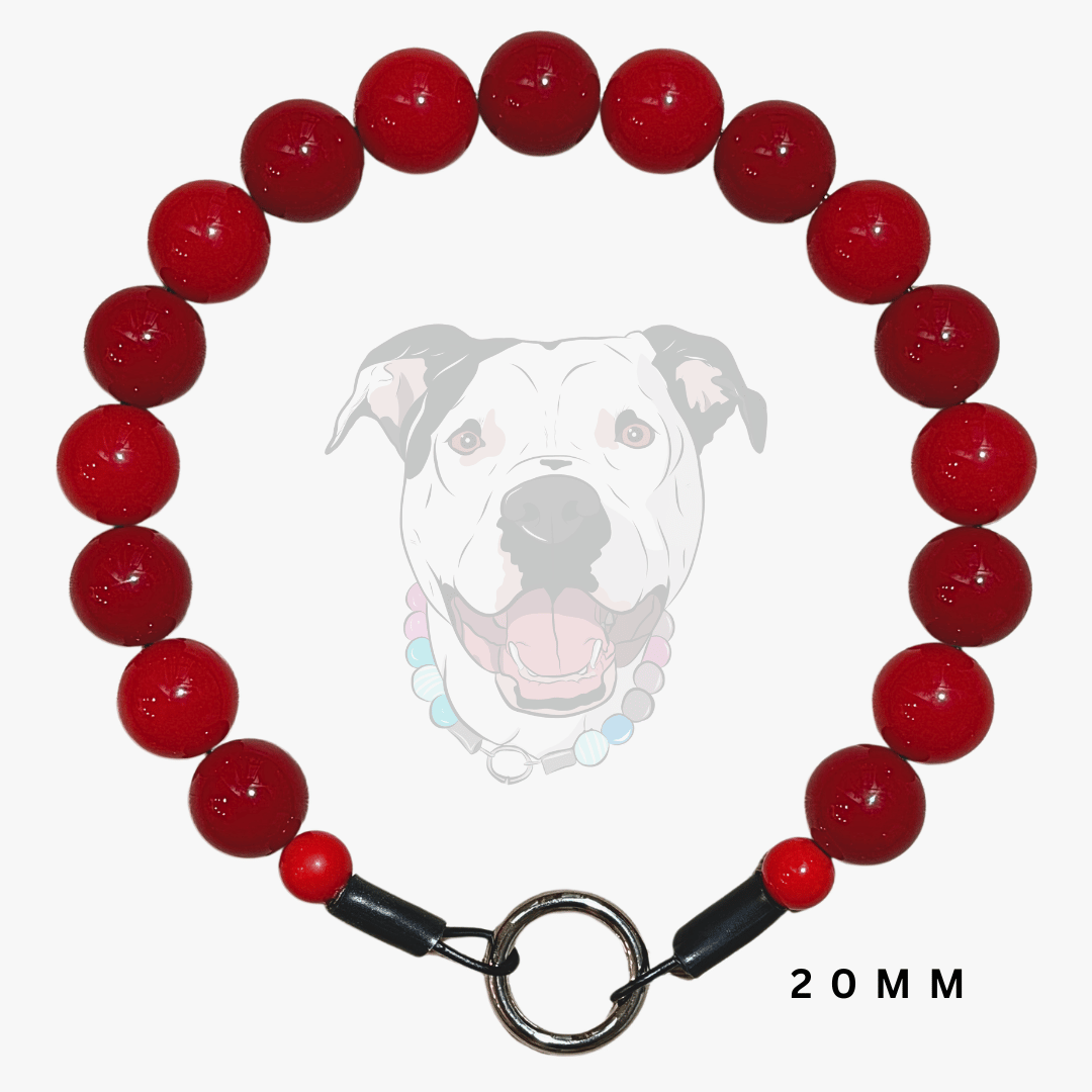 A red beaded dog collar with a silver-toned split ring and black toggle clasp, displayed against a light gray background with a faint dog graphic and '20MM' text.