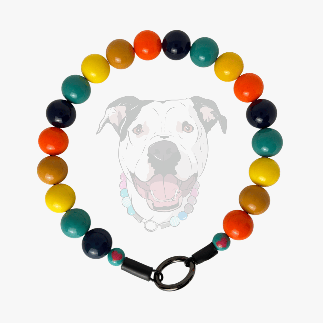 Uptown Dawgs Custom beaded pet Collar featuring their brand colors on a white background with a dogs face in the middle. 