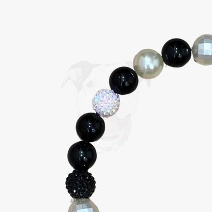 Beaded bracelet with black, white, and clear beads on a white background