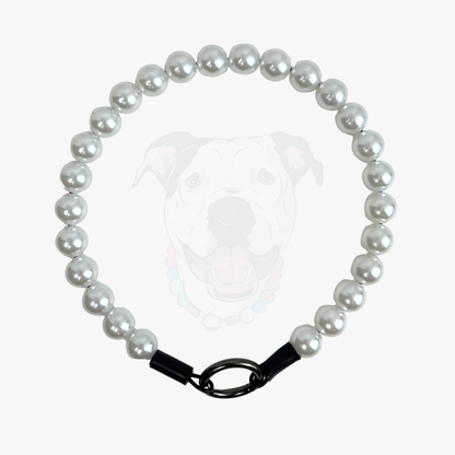 Pearl necklace with a black clasp on a white background