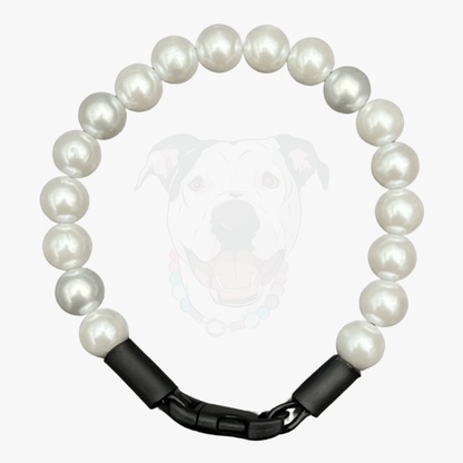 Pearl bracelet with black metal clasp on a white background