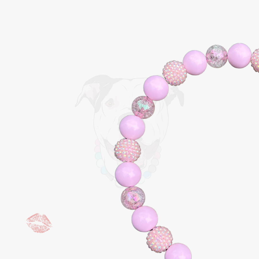 Pink bubblegum necklace on a white background