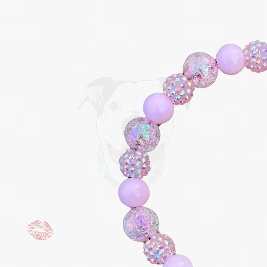 Bracelet with pink and iridescent beads on a white background