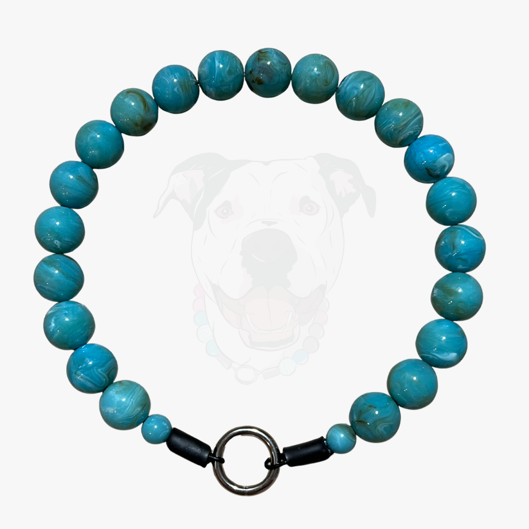 Turquoise beaded bracelet with a black clasp on a white background