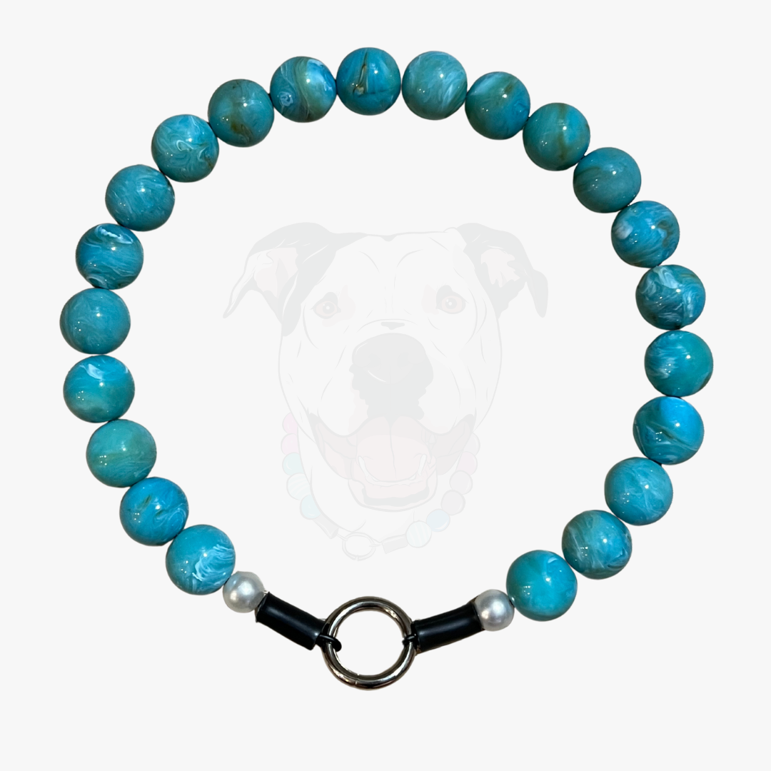 Turquoise beaded bracelet with a black clasp on a white background