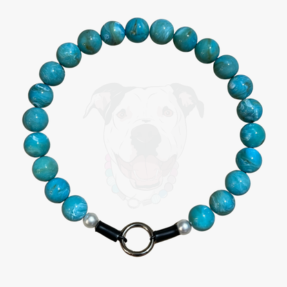 Turquoise beaded bracelet with a black clasp on a white background