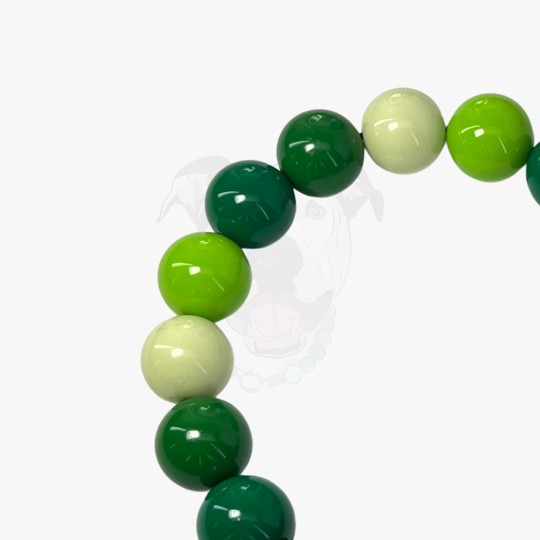 Green and white beaded bracelet on a white background