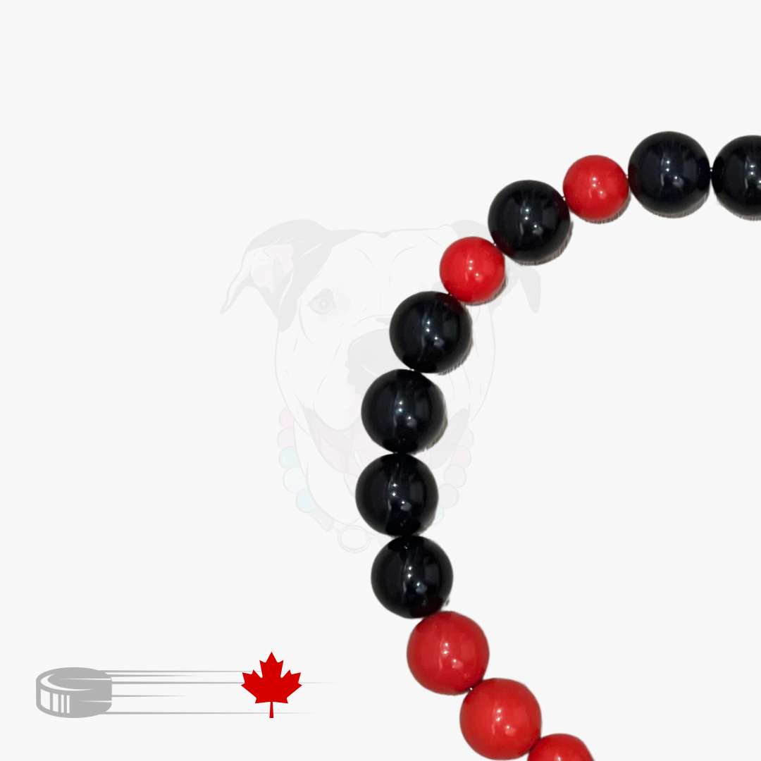 Beaded bracelet with black and red beads on a white background