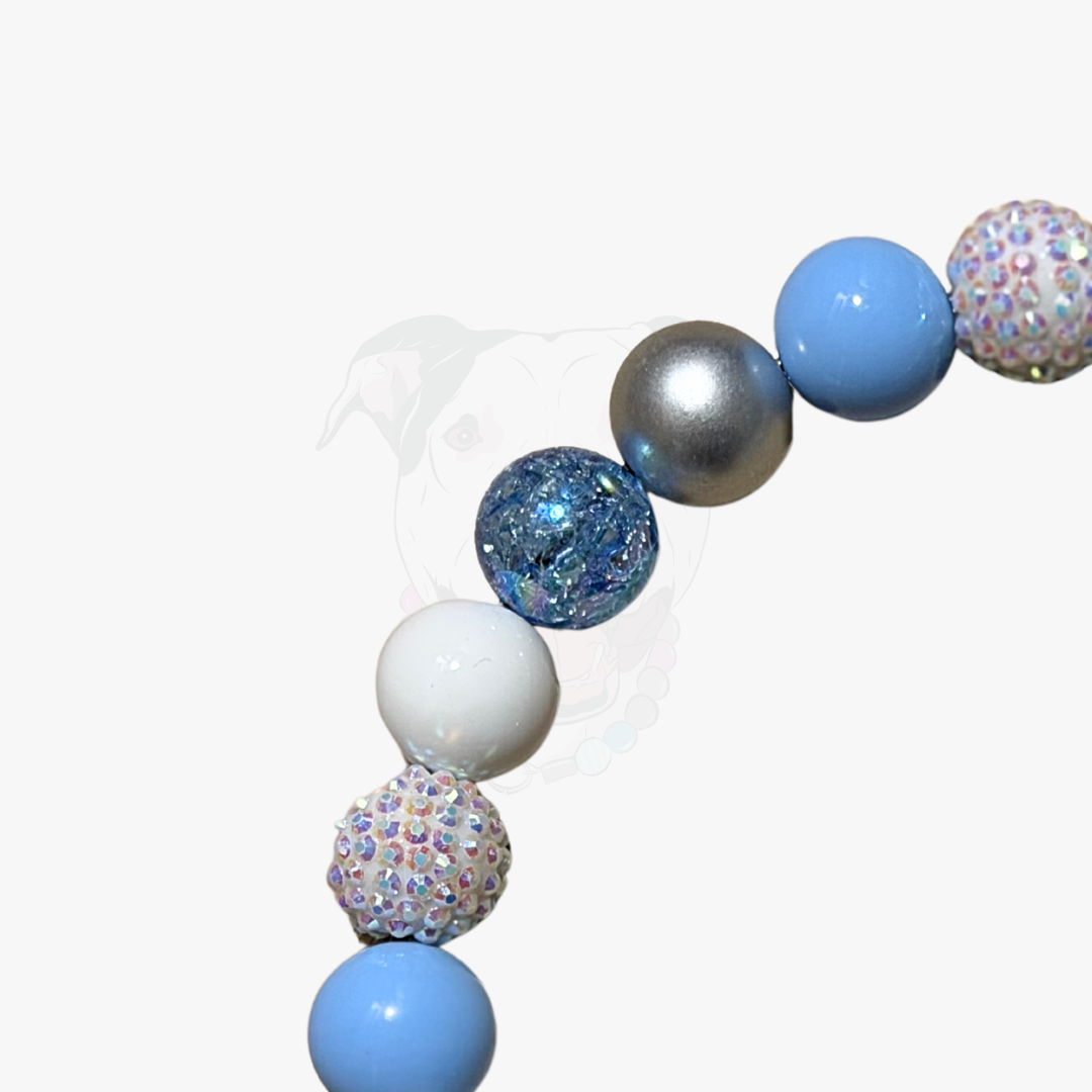 Decorative garland with blue, silver, and white balloons on a white background