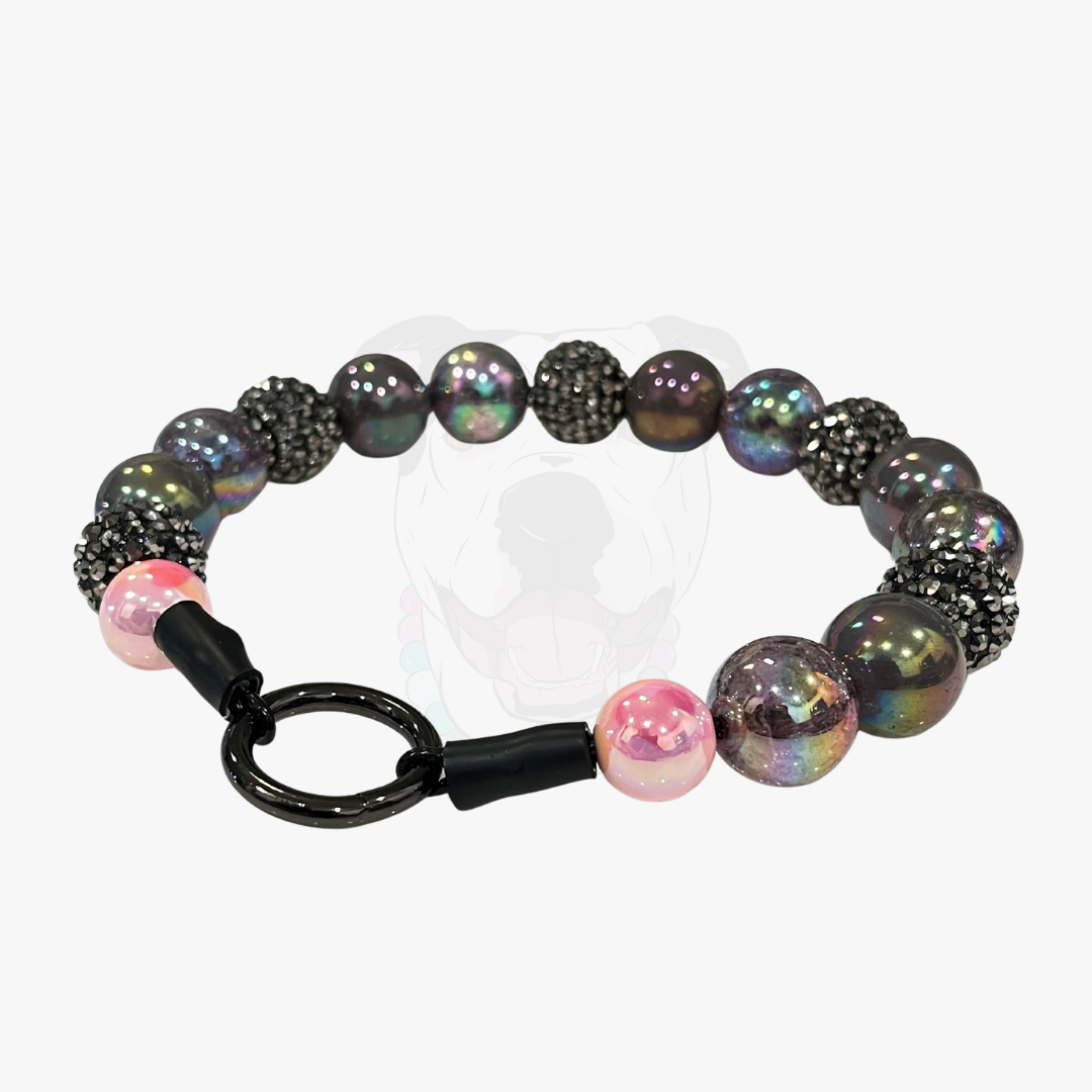 Bracelet with black and pink beads on a white background