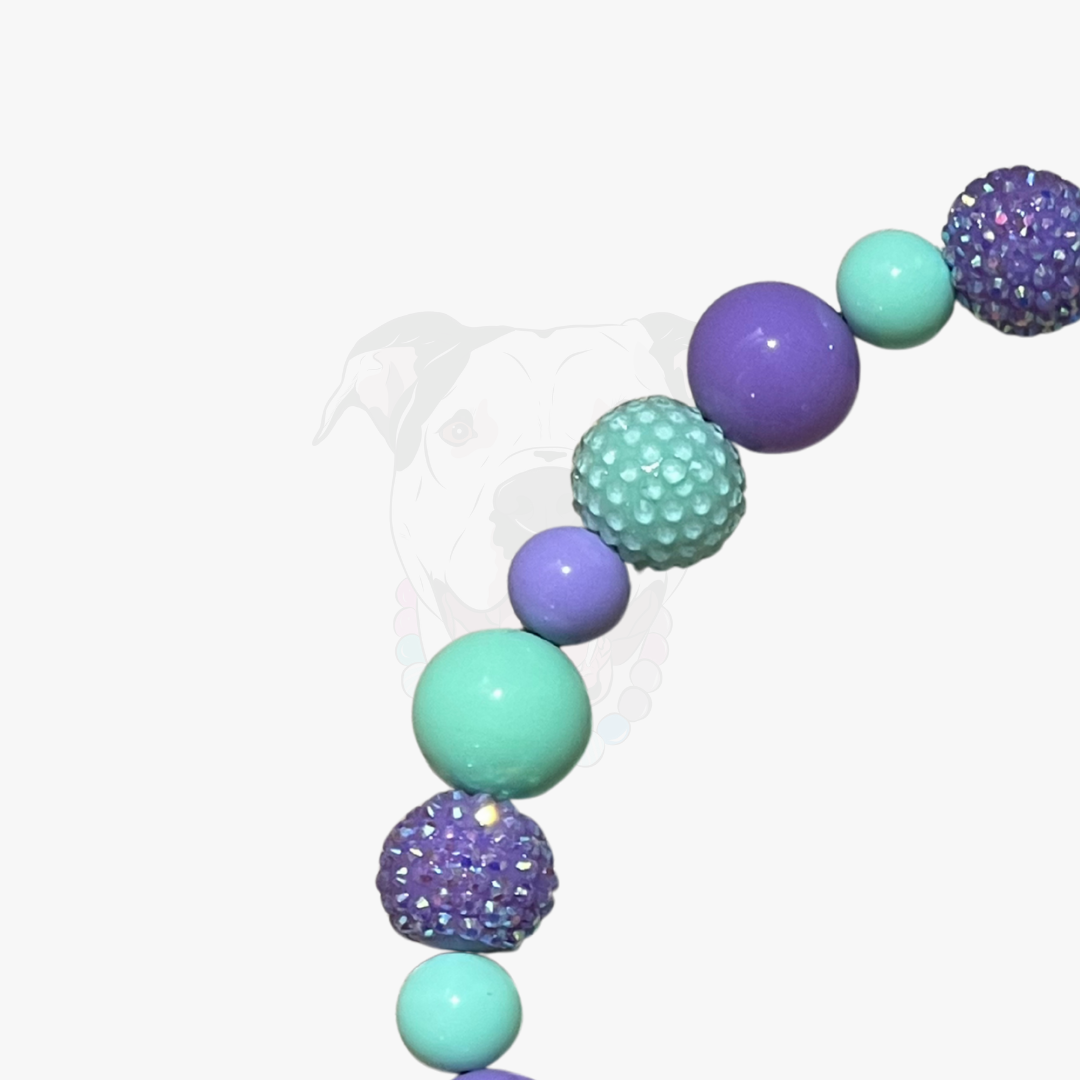 Decorative garland with purple and turquoise balloons on a white background