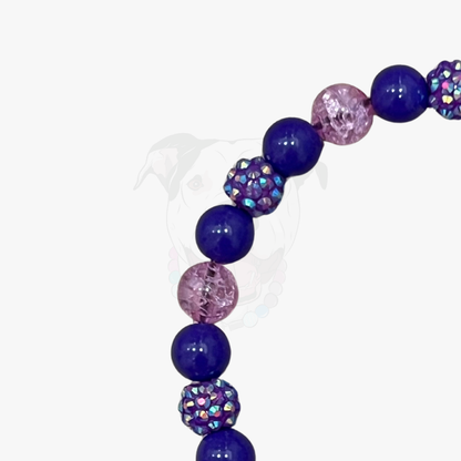 Beaded bracelet with blue and pink beads on a white background