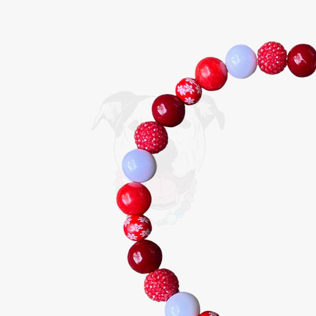 Beaded bracelet with red, white, and pink beads on a white background