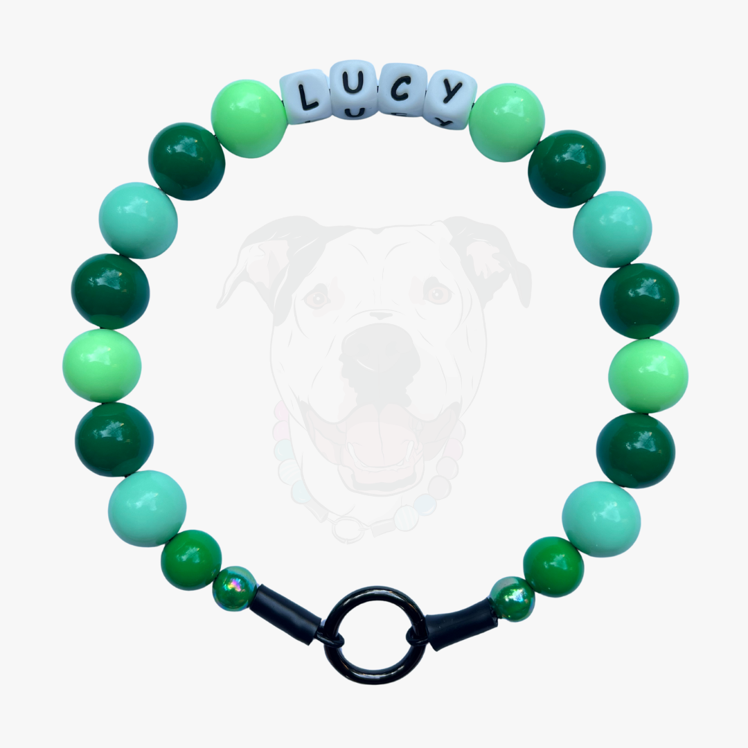 Green and teal beaded bracelet with a black clasp on a white background