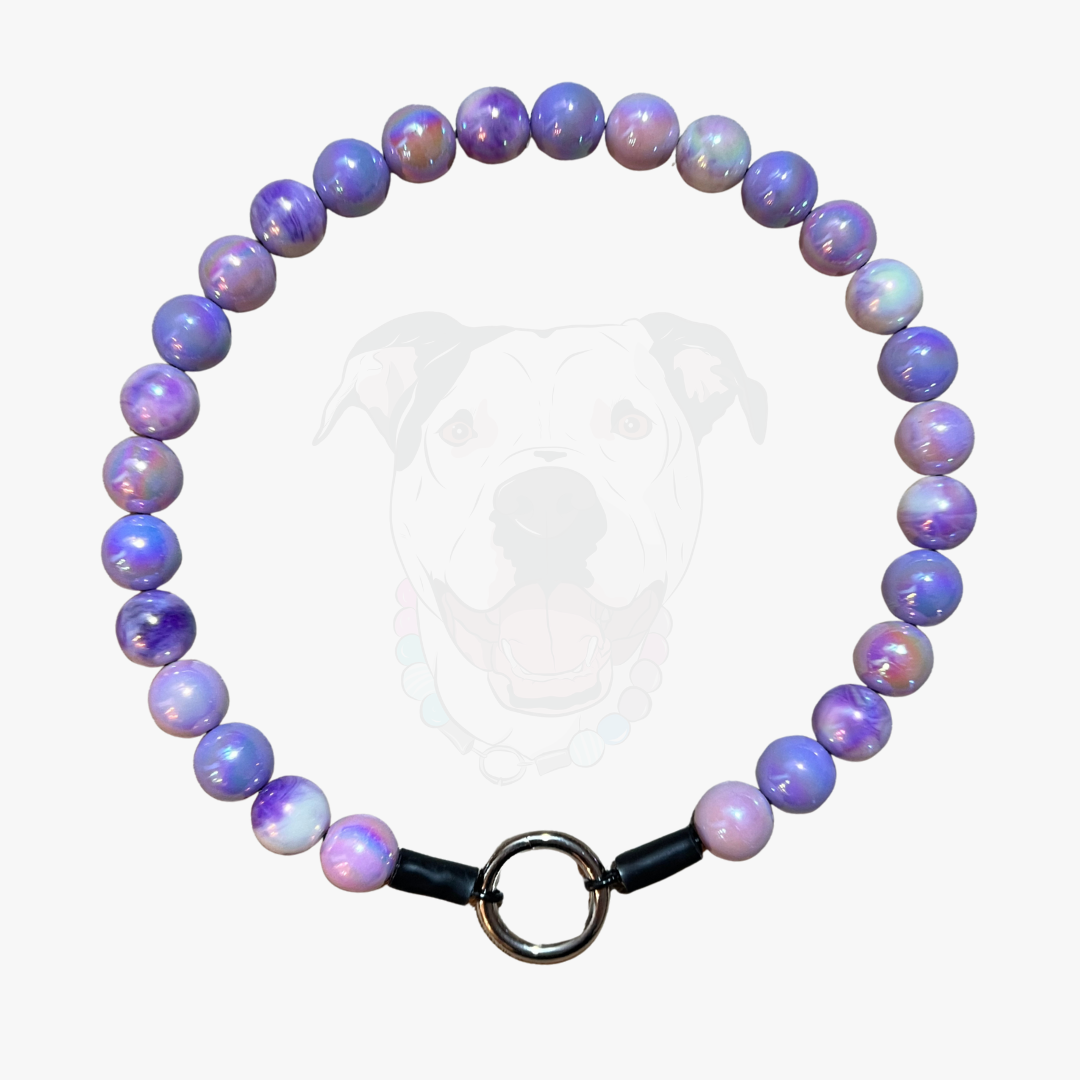 Purple beaded bracelet with a metal ring on a white background
