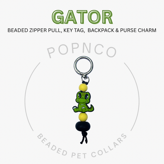 Gator-shaped beaded zipper pull, key tag, backpack & purse charm with Popnco branding on a white background.