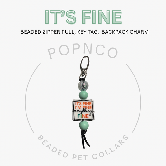 Beaded zipper pull, key tag, or backpack charm with 'It's Fine' message on a white background.