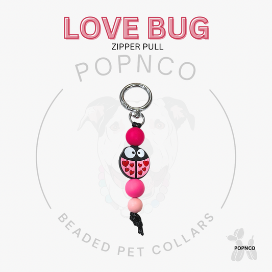 Love Bug zipper pull with pink and black design on a white background, featuring the brand 'POPNCO'.