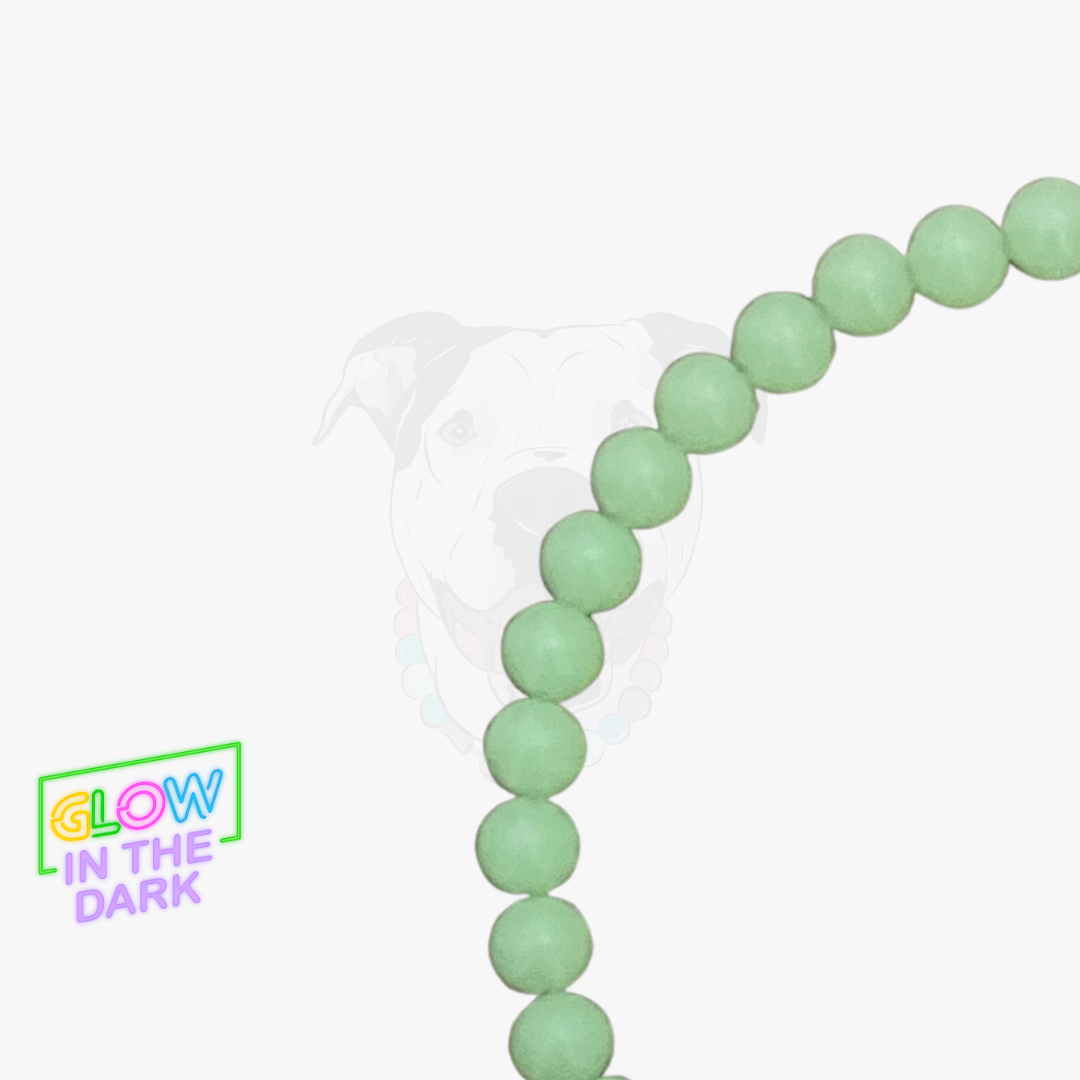 Green beaded bracelet with 'Glow in the Dark' label on a white background