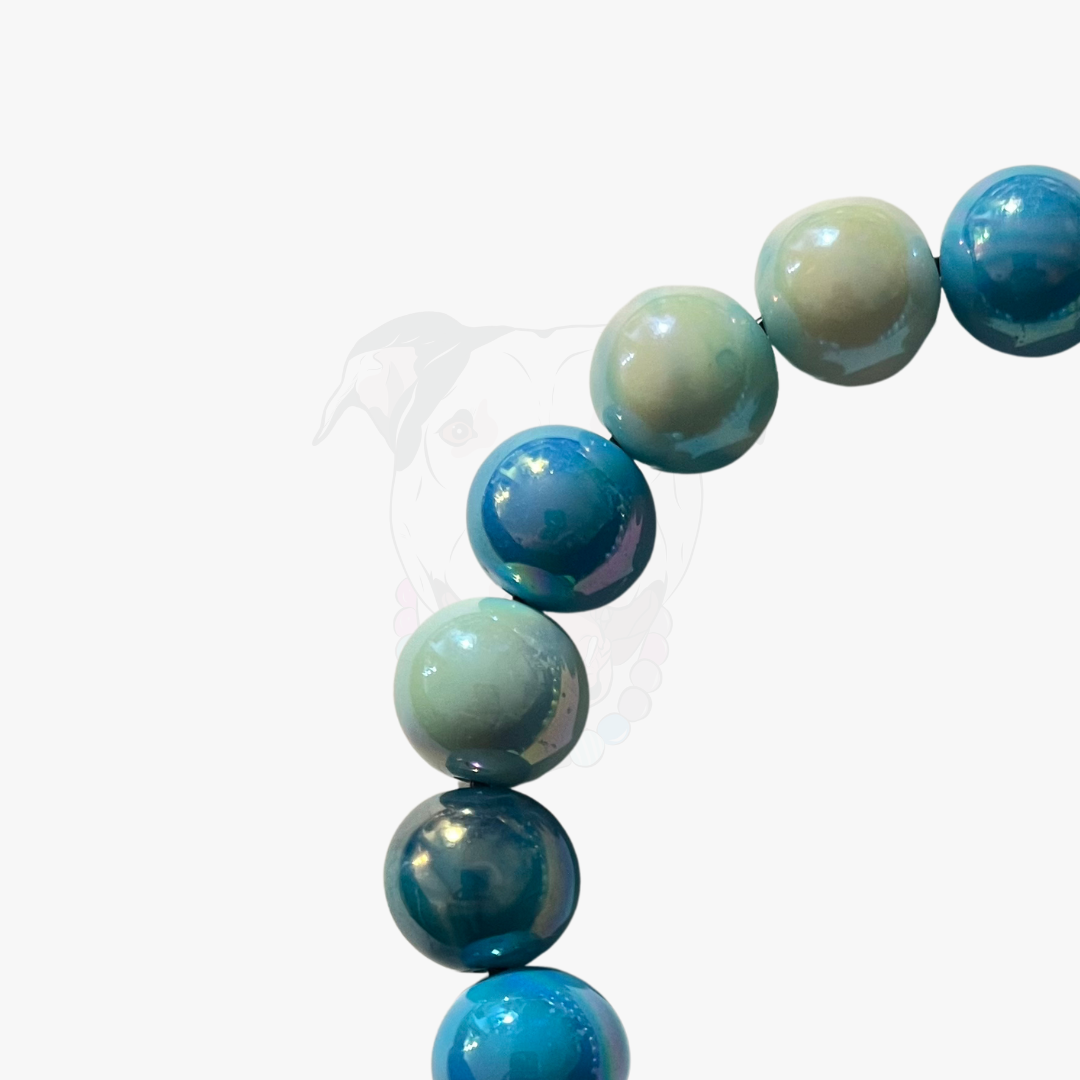 Close up of The Nelson beaded dog collar by POPNCO, featuring bright, iridescent AB acrylic beads that shimmer in the light, strung on heavy-duty cable.