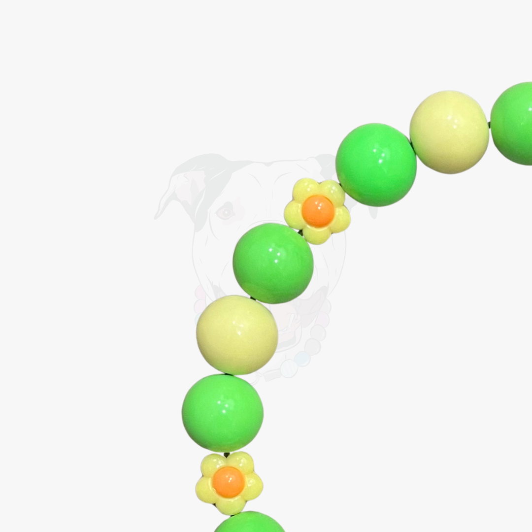 Close up of bright green yellow and flower shaped acrylic beads used in the Vern collar by POPNCO. handcrafted in BC.