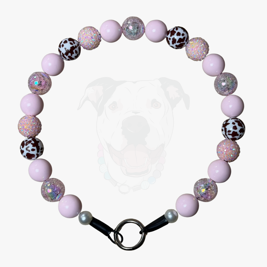 POPNCO handcrafted beaded pet collar Jolene laying flat on a white background featuring pale pink solid, crackle and rhinestone bayberries mixed with brown cow print beads. 