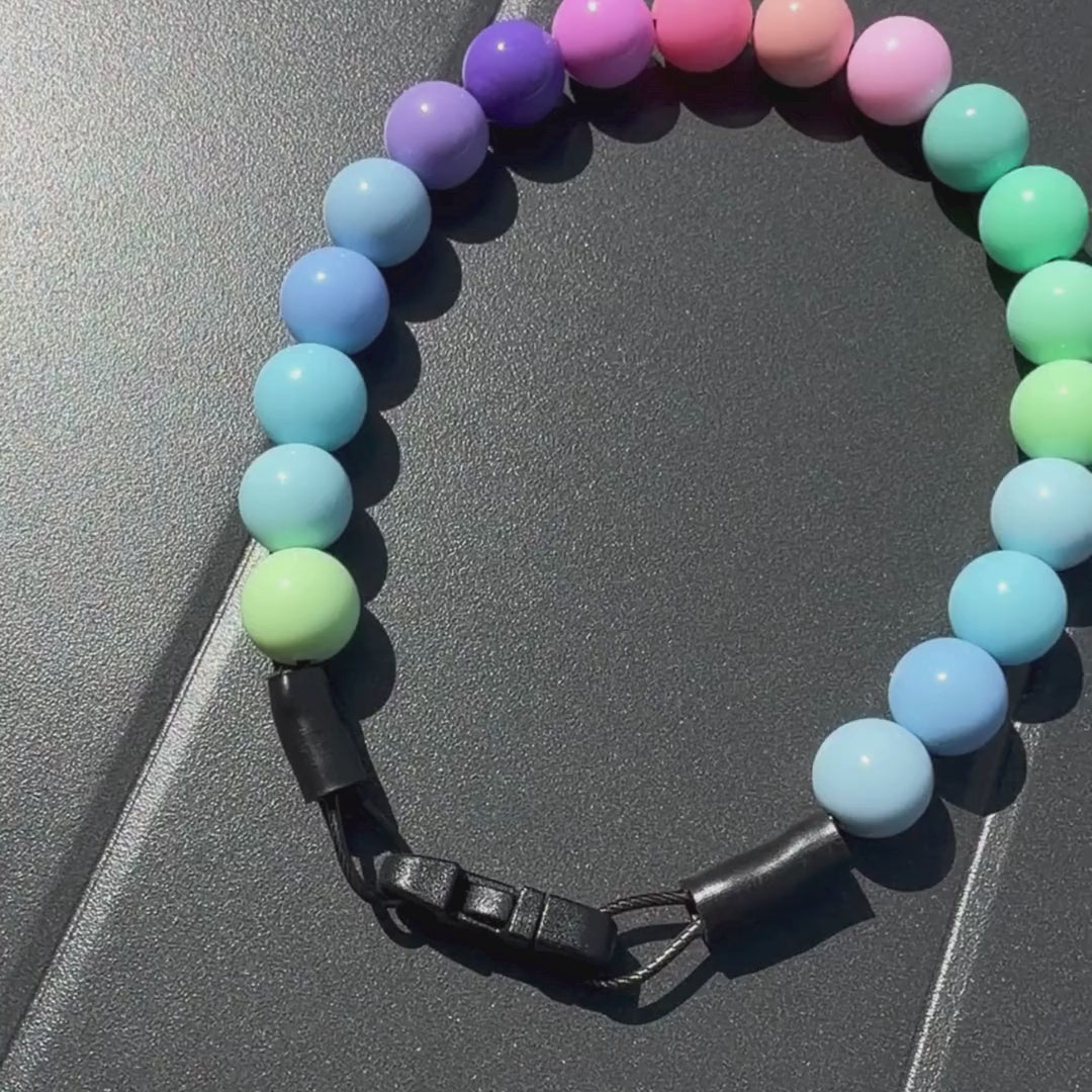 Video of POPNCO Pastel Rainbow Beaded Pet Collar laying flat on a Grey Surface 