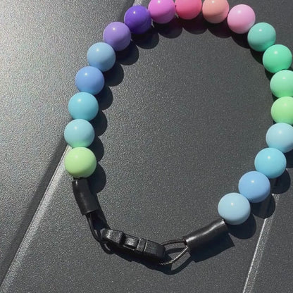 Video of POPNCO Pastel Rainbow Beaded Pet Collar laying flat on a Grey Surface 