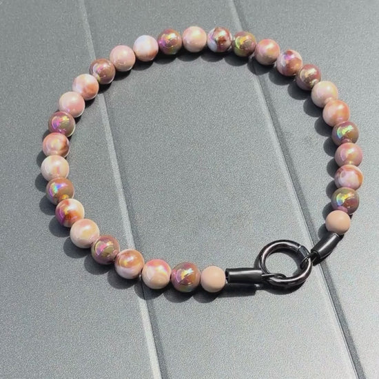 Close up of The Ned beaded dog collar by POPNCO, featuring bright, iridescent AB acrylic beads that shimmer in the light, strung on heavy-duty cable.