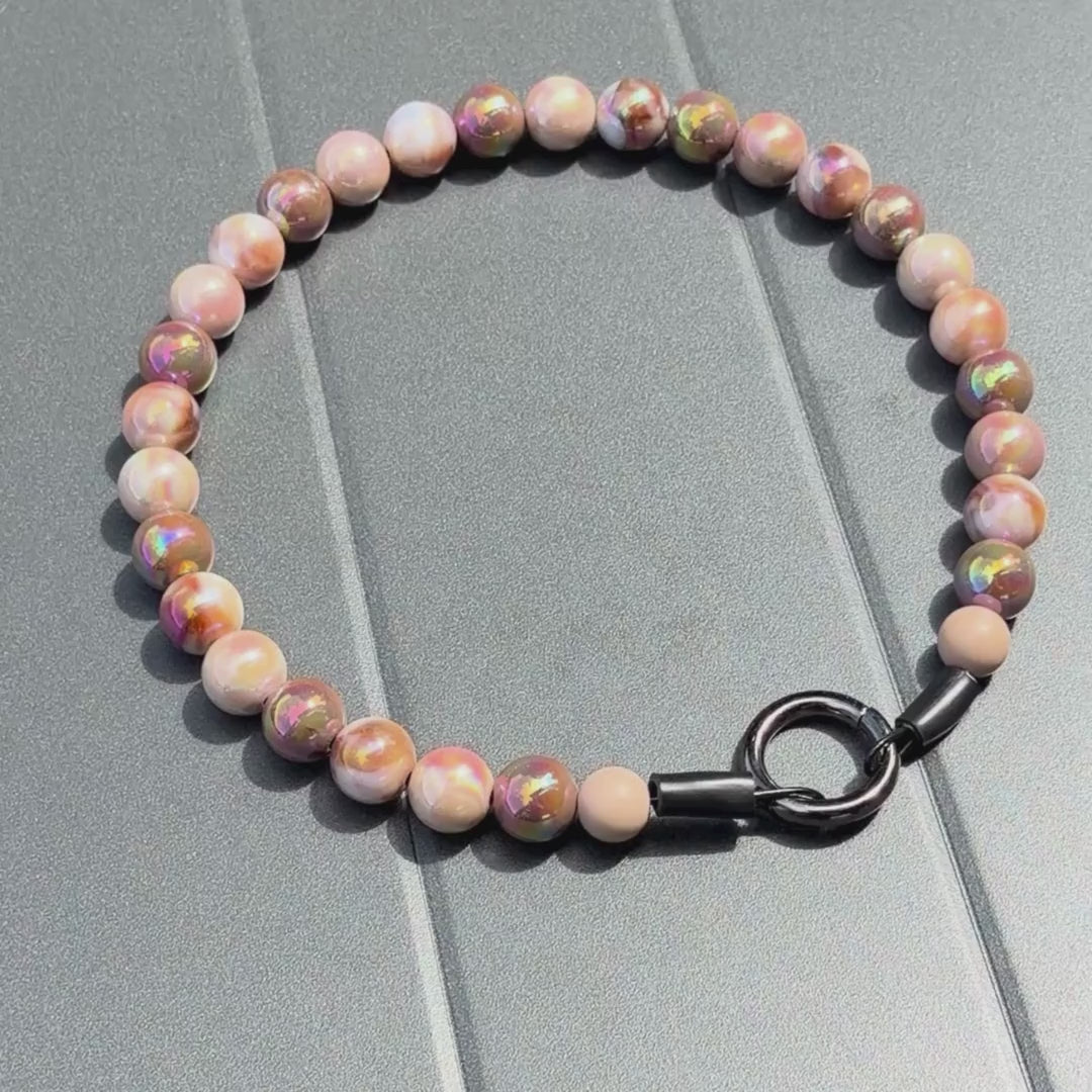 Close up of The Ned beaded dog collar by POPNCO, featuring bright, iridescent AB acrylic beads that shimmer in the light, strung on heavy-duty cable.