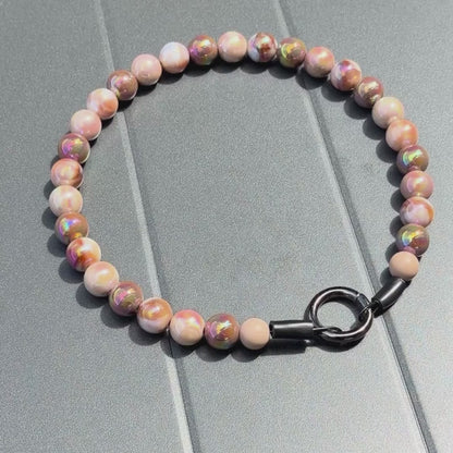 Close up of The Ned beaded dog collar by POPNCO, featuring bright, iridescent AB acrylic beads that shimmer in the light, strung on heavy-duty cable.