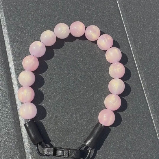 Video of the Giselle Pink Sparkly Galaxy 12mm  POPNCO beaded collar from the galaxy collection on a black grey table. 