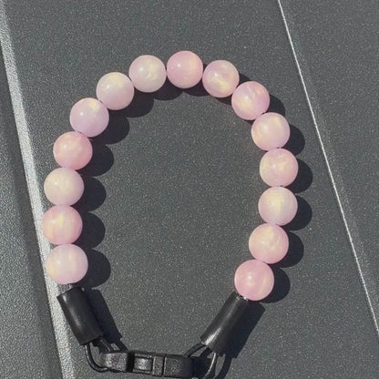 Video of the Giselle Pink Sparkly Galaxy 12mm  POPNCO beaded collar from the galaxy collection on a black grey table. 